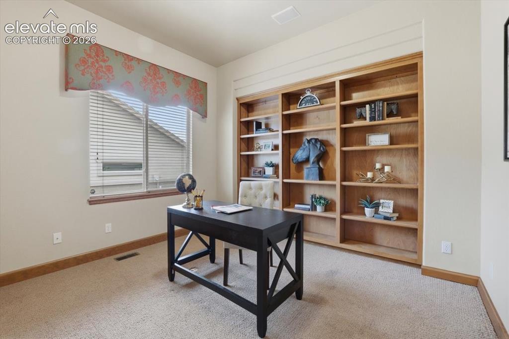 Image 17 of 32: Second Bedroom on Main Level has Built-ins and can be an Office!
