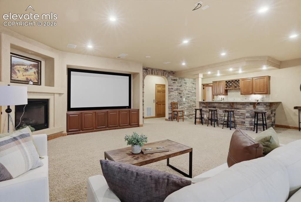 Image 24 of 32: Doubles as the Home Theater Room with speakers and screen ready to go! Gas