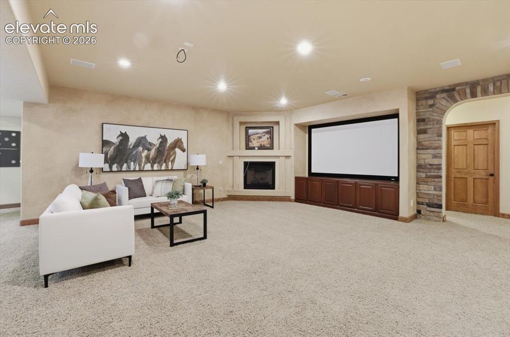 Image 25 of 32: Family Room Doubles as the Home Theater Room with speakers and screen ready