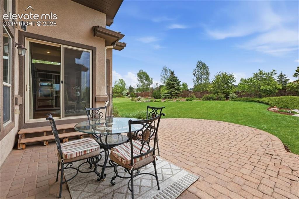 Image 30 of 32: Paver patio with covering, speakers, and a natural gas line for grilling!
