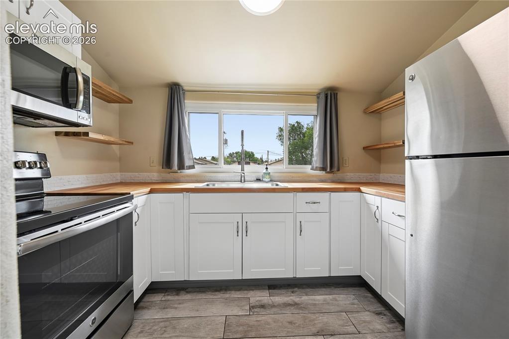 Image 30 of 50: Kitchen in upstairs apartment with