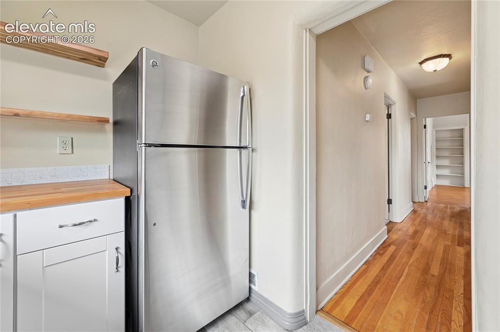 Image 31 of 50: Kitchen in upstairs apartment looking toward hallway