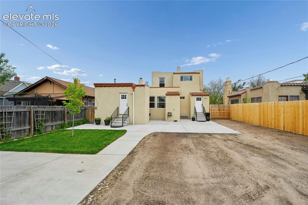 Image 42 of 50: Back of home with huge patio