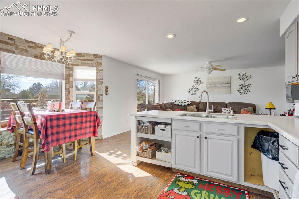 Image 12 of 27: Kitchen featuring light countertops, open floor plan, dark wood-style floor