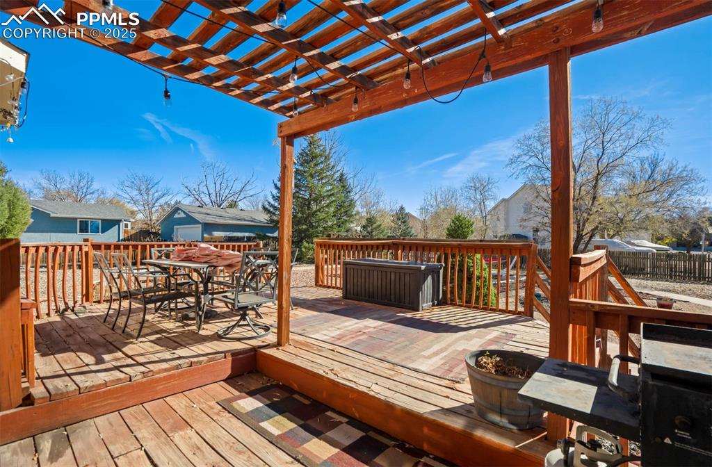Image 27 of 27: Wooden deck featuring outdoor dining space