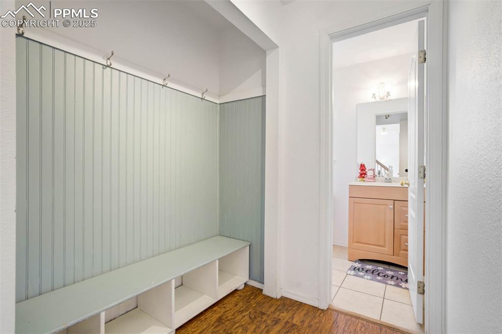 Image 28 of 39: Mudroom with dark wood-style floors