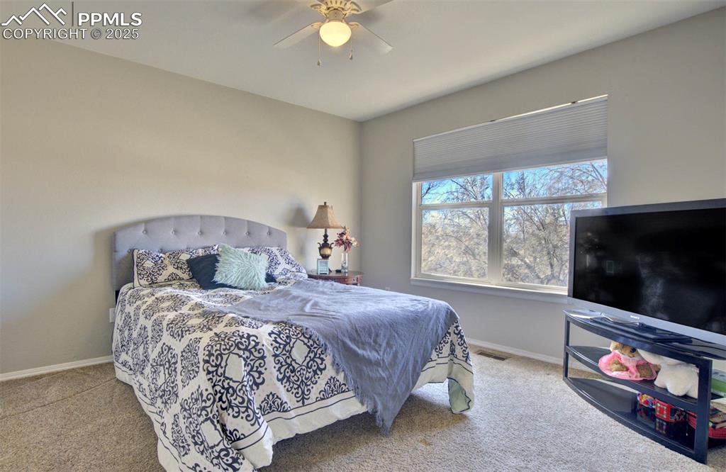 Image 32 of 39: Carpeted bedroom featuring baseboards and a ceiling fan
