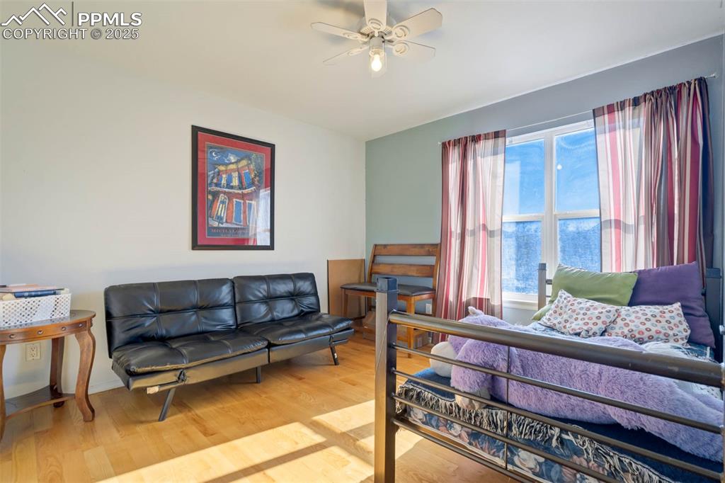 Image 34 of 39: Bedroom featuring wood finished floors and a ceiling fan