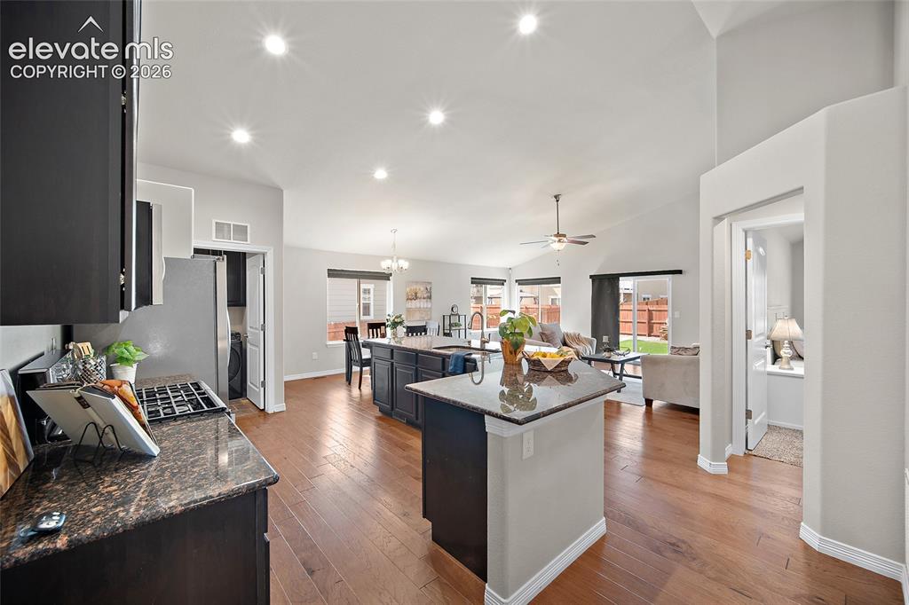 Image 3 of 29: Expansive open concept interior with wood-finish flooring, recessed lightin