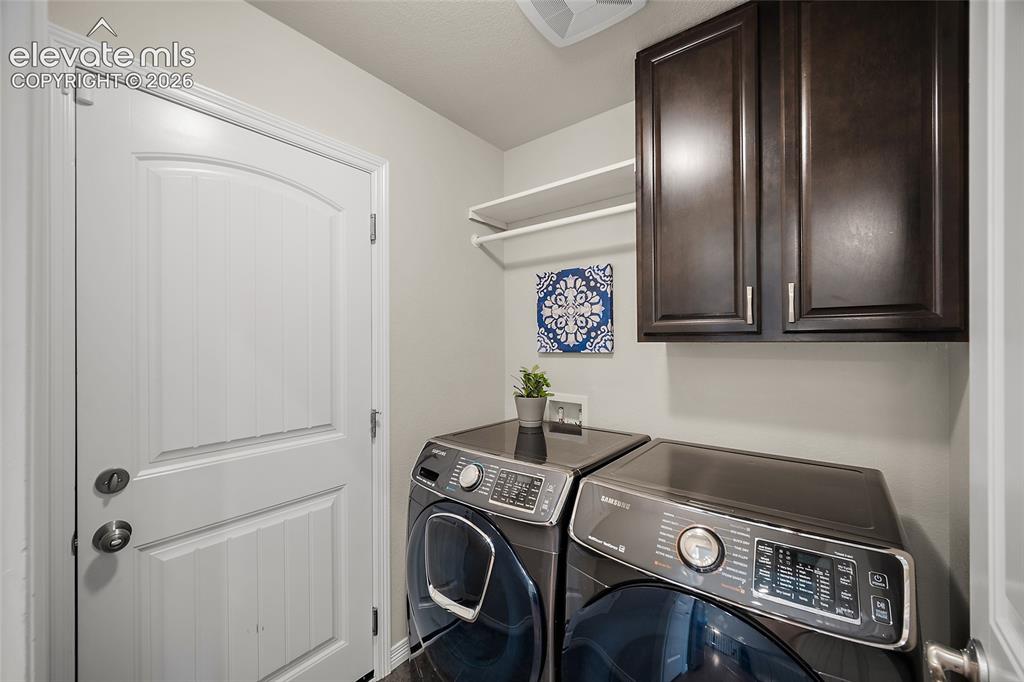Image 8 of 29: Built-in dark wood cabinetry, white wall-mounted shelving, and wood-finish 