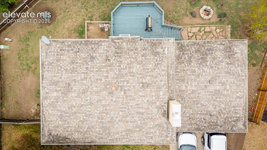 Image 4 of 50: Overhead view showcasing the asphalt shingle roof, multi-level wood deck, s