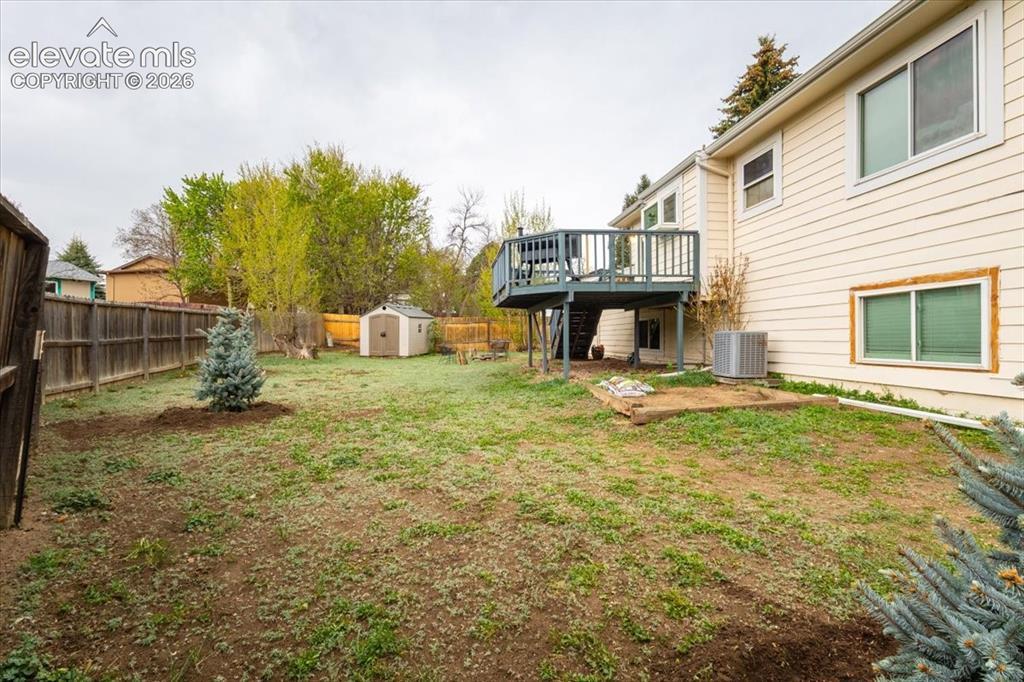 Image 47 of 50: Expansive backyard featuring a fenced perimeter, a rear deck with stairs, a