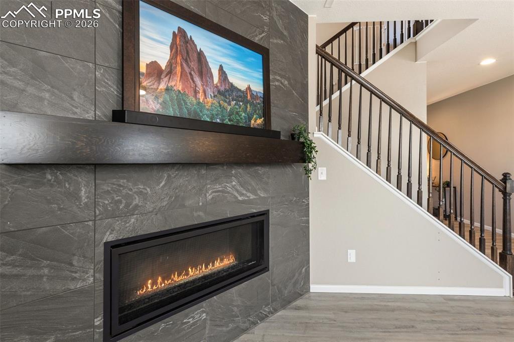 Image 11 of 49: Floor-to-ceiling tile fireplace with oversized cosmopolitan fireplace