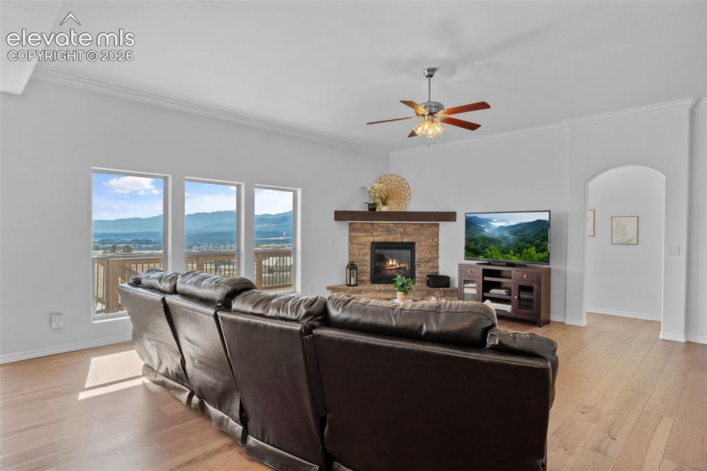 Image 10 of 50: Light wood-finish flooring complements white walls and crown molding