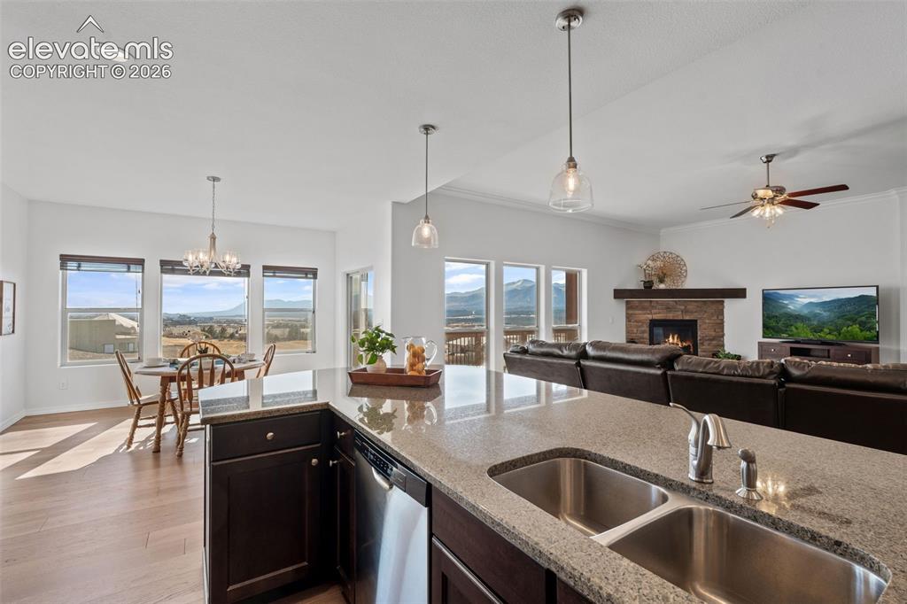 Image 20 of 50: Kitchen island featuring a double basin stainless steel sink, a pull-down f