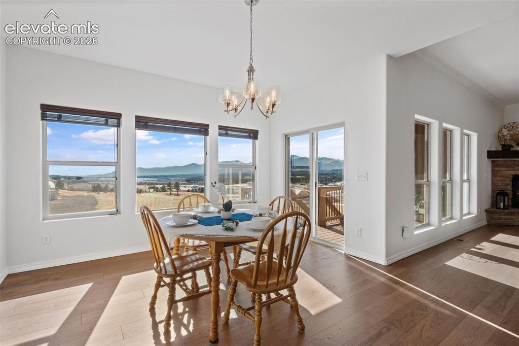 Image 21 of 50: Dining area featuring expansive windows, wood-finish flooring, a sliding gl