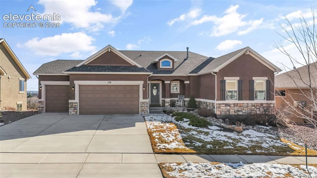 Image 3 of 50: Ranch-style residence featuring a stucco exterior with stone accents, a two