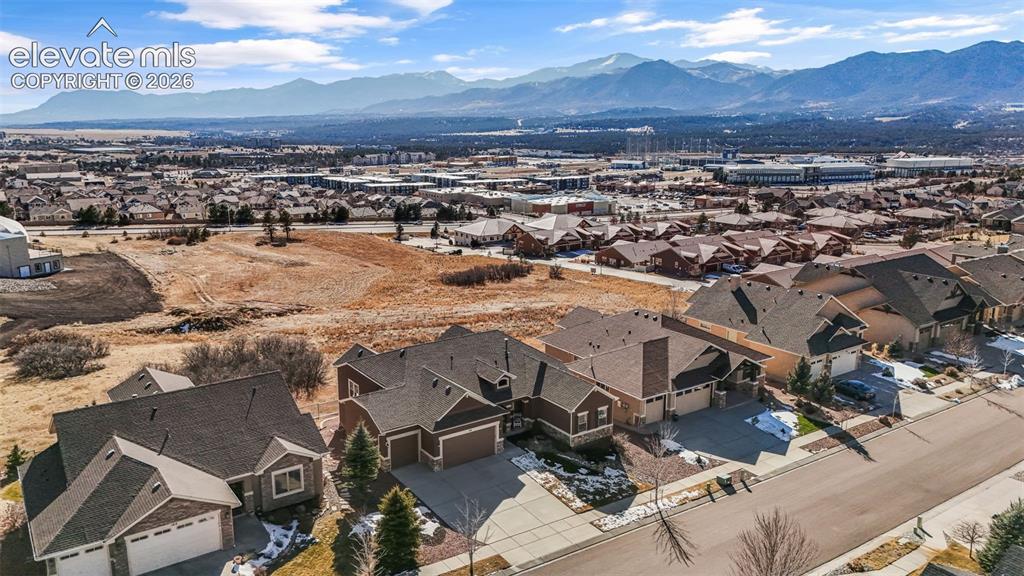 Image 4 of 50: Residential neighborhood with diverse home styles, paved streets, and a bac