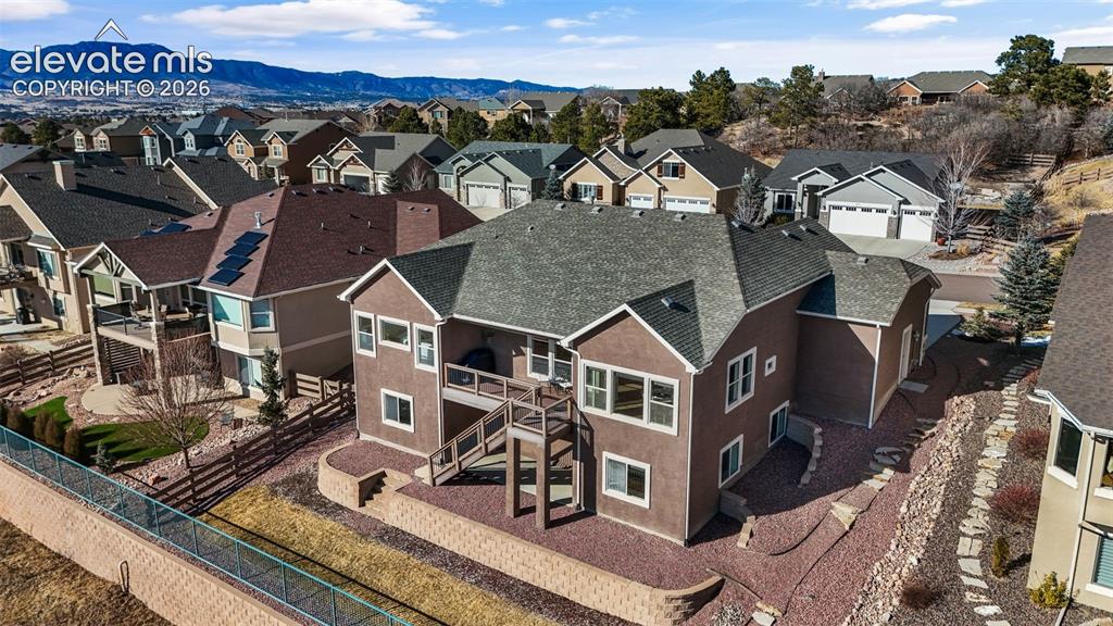 Image 46 of 50: Two-story residence featuring a multi-level deck, lower patio, and terraced