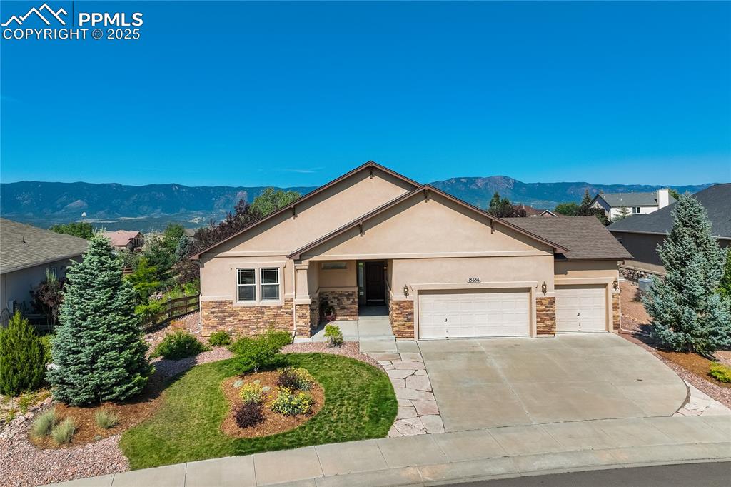 Caption: Classic Colorado curb appeal with stucco + stone exterior, nestled on a premium lot backing to open 