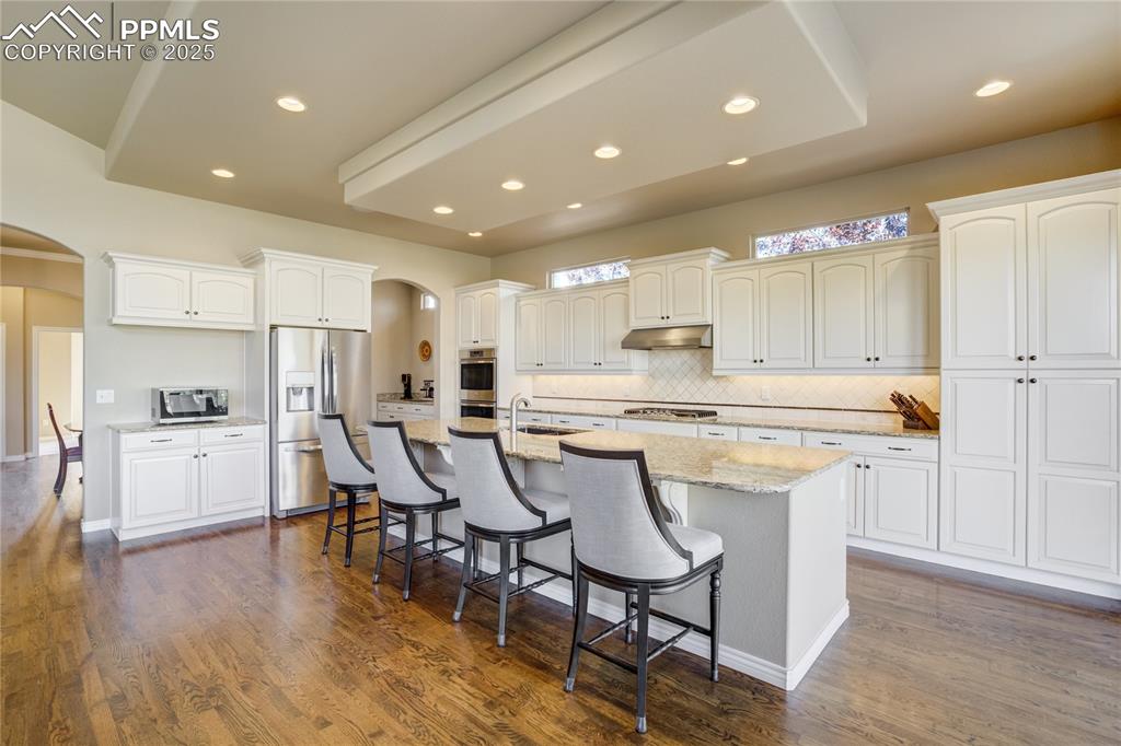 Image 10 of 50: A kitchen that balances beauty + function: staggered white maple cabinetry,