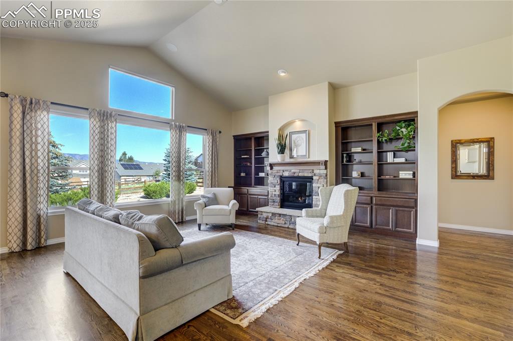 Image 6 of 50: A warm welcome — hardwood floors, soaring ceilings, and natural light set t