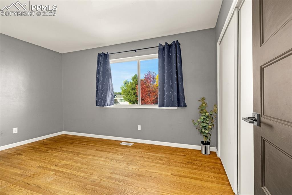 Image 13 of 33: Spare room featuring light wood finished floors