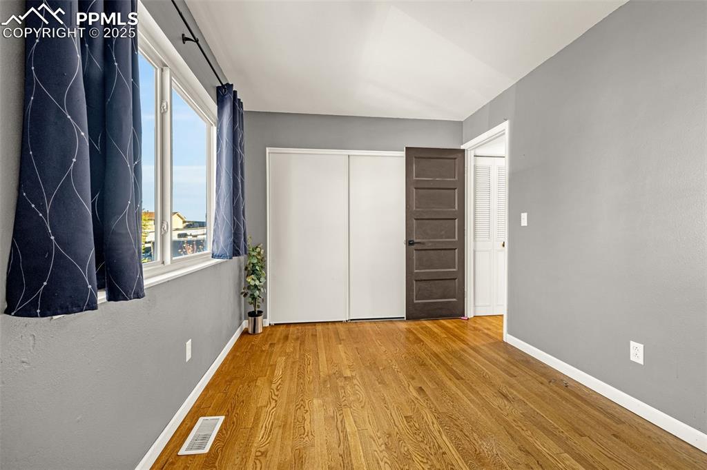 Image 14 of 33: Unfurnished bedroom featuring a closet and wood finished floors
