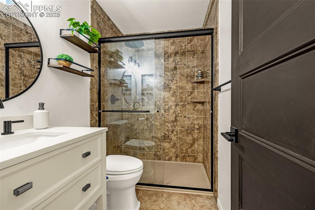 Image 15 of 33: Full bath with vanity and a shower stall