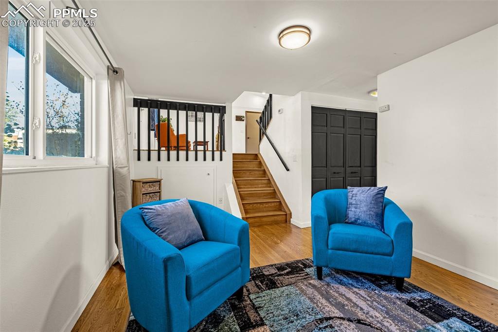 Image 17 of 33: Living area featuring wood finished floors and stairs