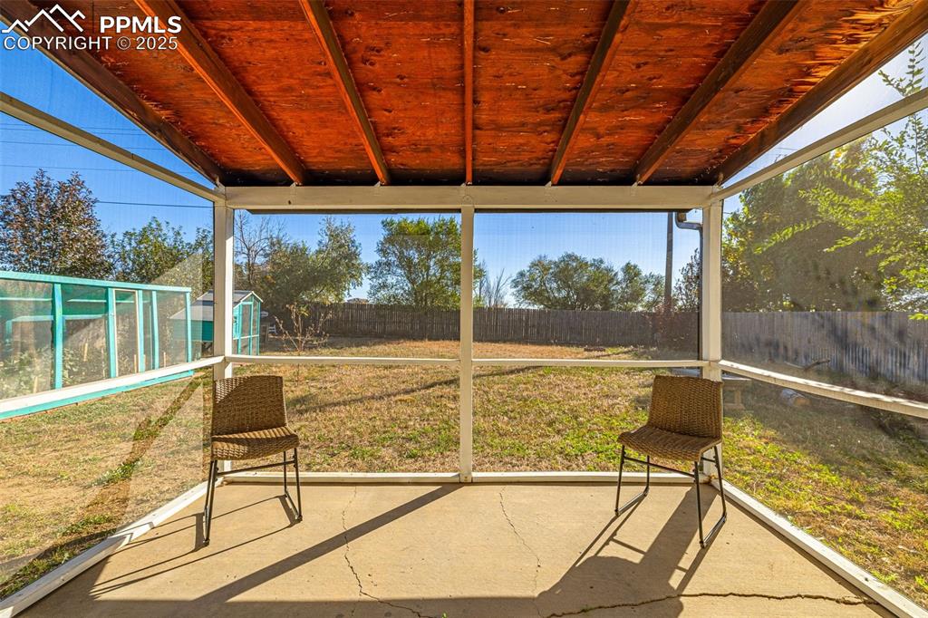 Image 23 of 33: Unfurnished sunroom with vaulted ceiling