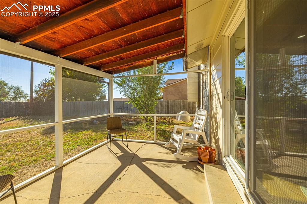 Image 24 of 33: Unfurnished sunroom with lofted ceiling and a patio