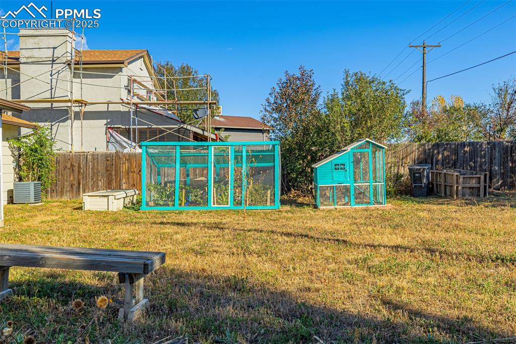 Image 26 of 33: Fenced backyard with exterior structure and an outdoor structure