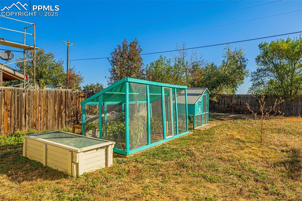 Image 27 of 33: View of poultry coop featuring a fenced backyard