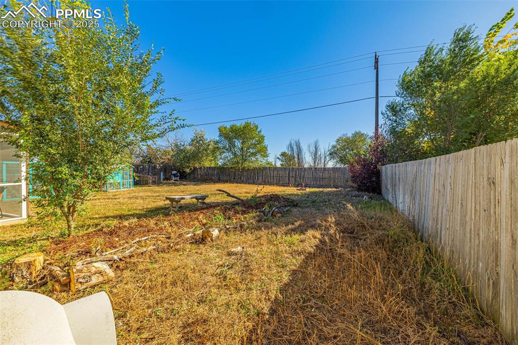 Image 28 of 33: View of fenced backyard