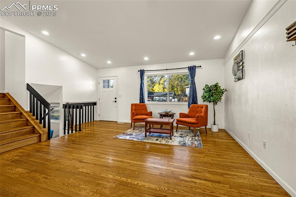 Image 5 of 33: Sitting room featuring recessed lighting, wood finished floors, an upstairs