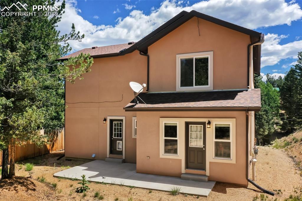 Image 3 of 46: View of front of property featuring stucco siding and a shingled roof