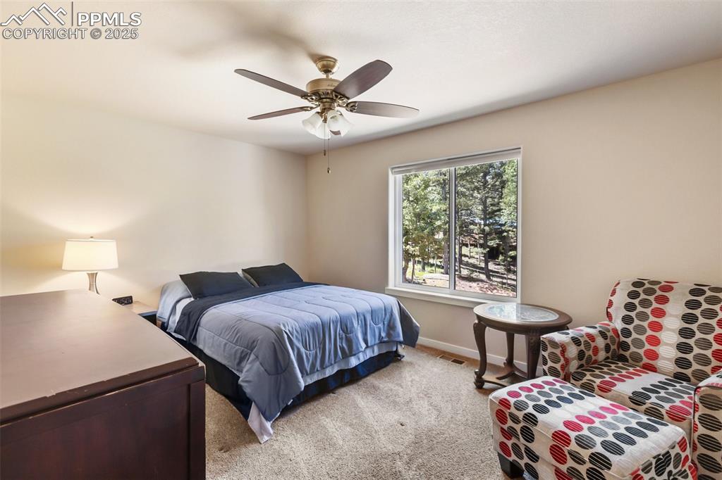 Image 44 of 46: Bedroom featuring light colored carpet and ceiling fan