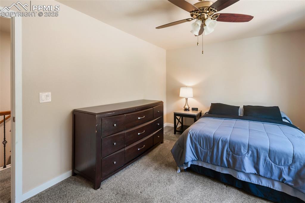 Image 46 of 46: Carpeted bedroom with baseboards and a ceiling fan