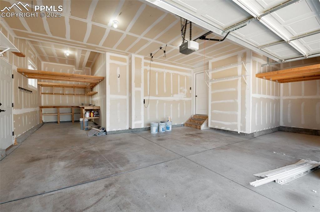 Image 42 of 49: 3 Car Tandem Garage with extra storage.