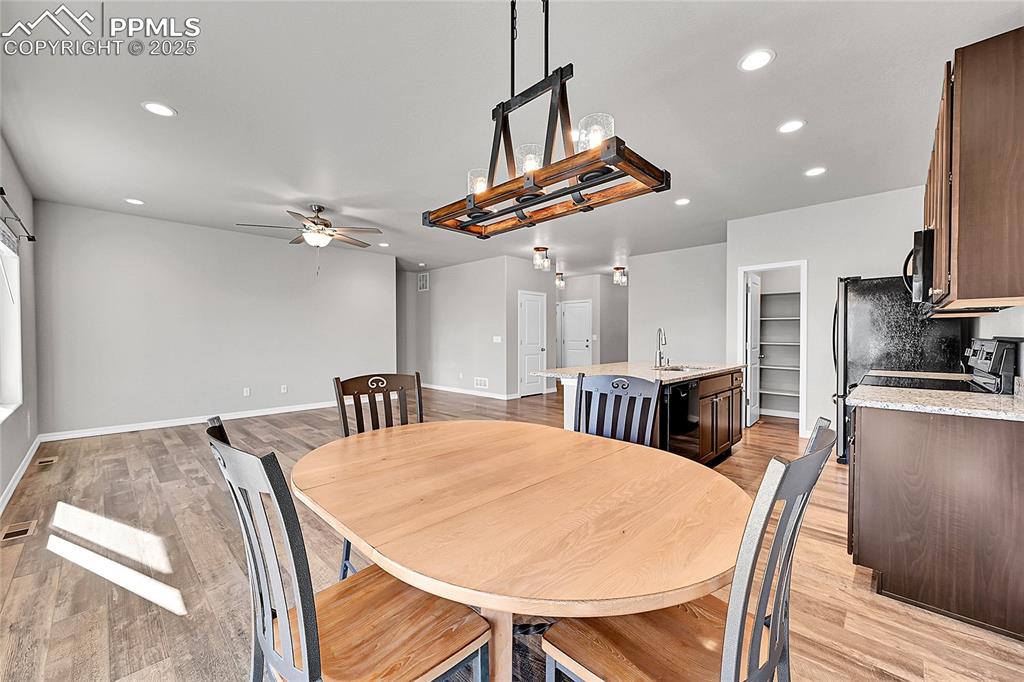 Image 14 of 43: Dining space featuring a ceiling fan, recessed lighting, and light wood-typ