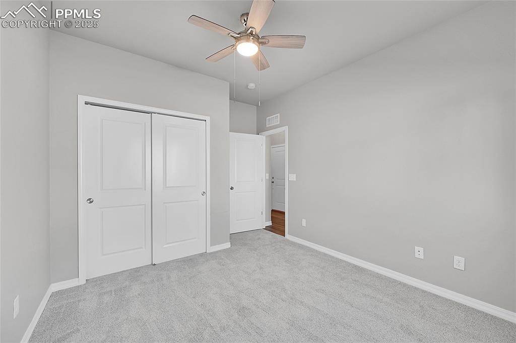Image 22 of 43: Bedroom featuring new carpet floors, a closet, and ceiling fan