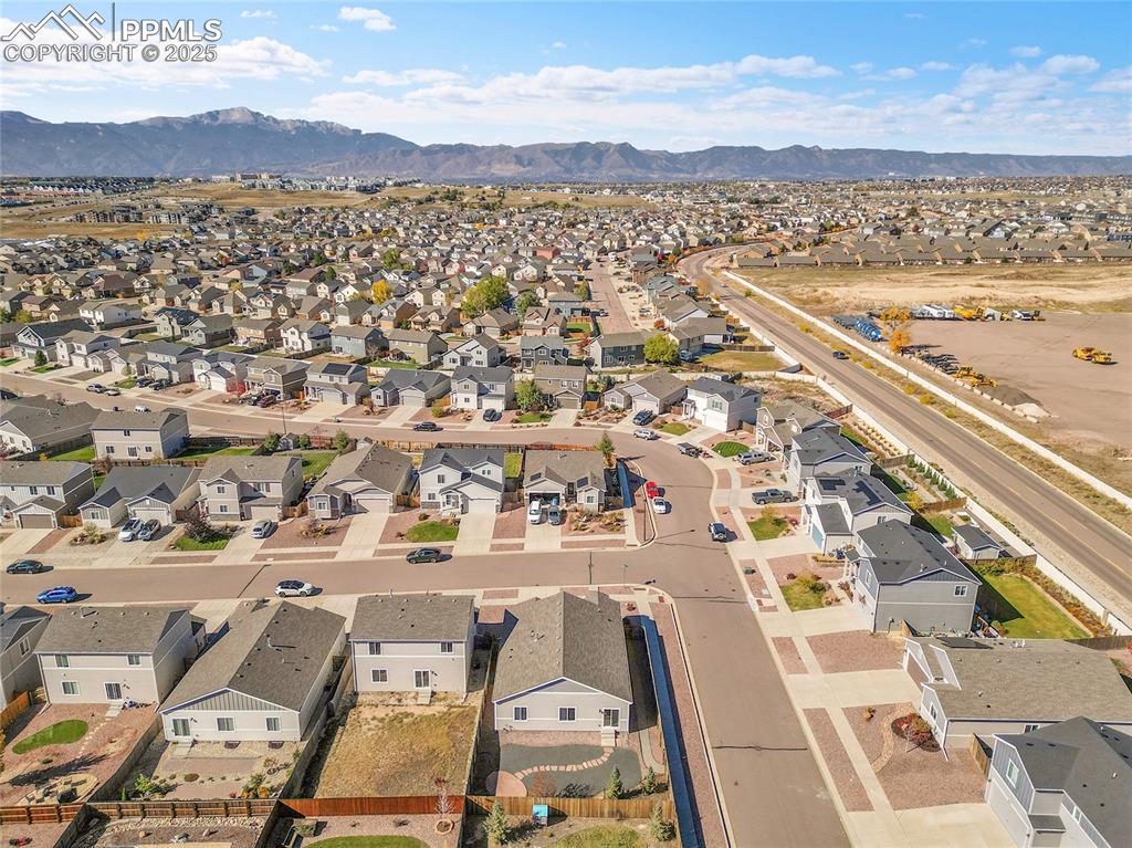Image 42 of 43: Aerial view of residential area featuring mountains