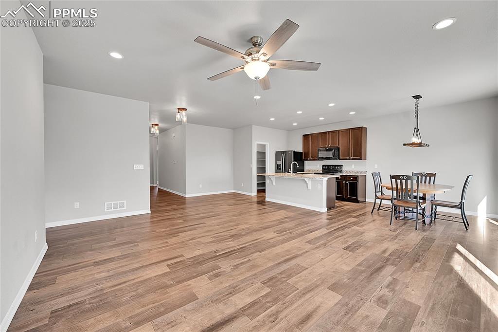Image 5 of 43: Living room open to Kitchen and Dining