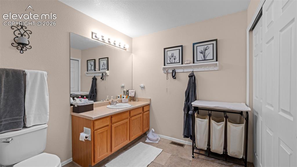 Image 17 of 28: Primary Bath with Good Counter Space, Double Closets, Tile Floor and Double
