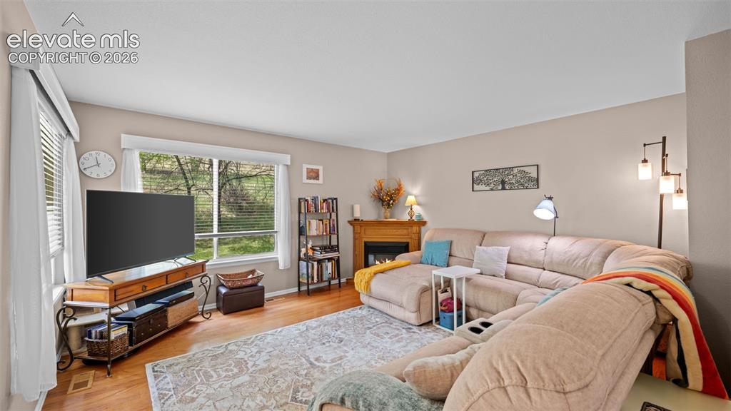 Image 2 of 28: Glowing Hardwood Floors ~ 2 Oversized Windows Allowing Great Views of The D