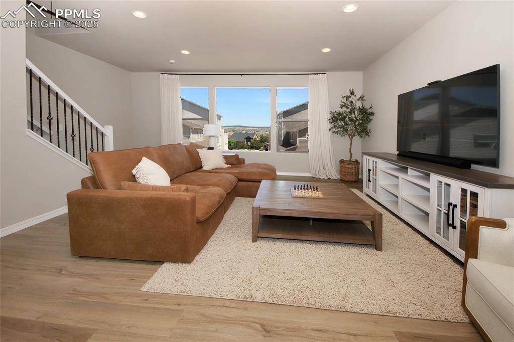 Image 16 of 38: Family Room with view out the front between buildings.