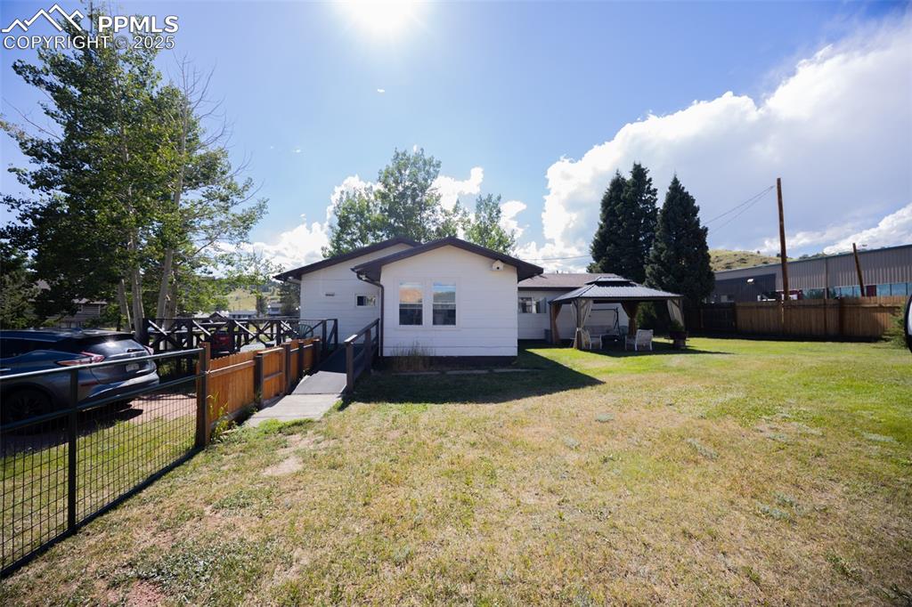 Image 20 of 34: Back of property featuring a gazebo