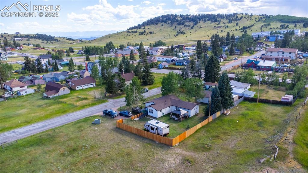 Image 33 of 34: Aerial perspective of suburban area featuring a mountain backdrop