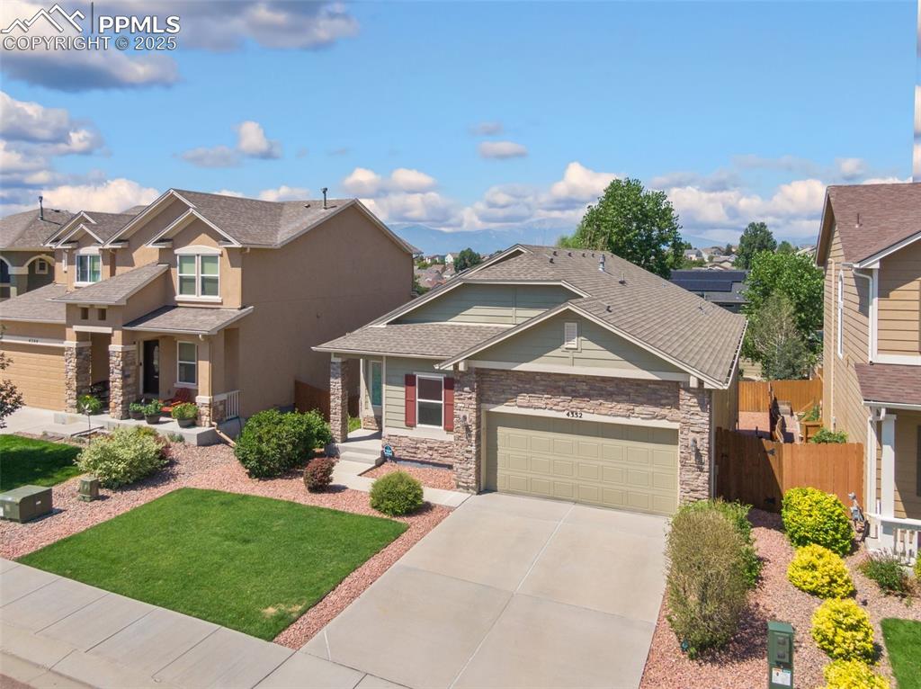Image 3 of 45: Craftsman-style house featuring concrete driveway, a residential view, ston